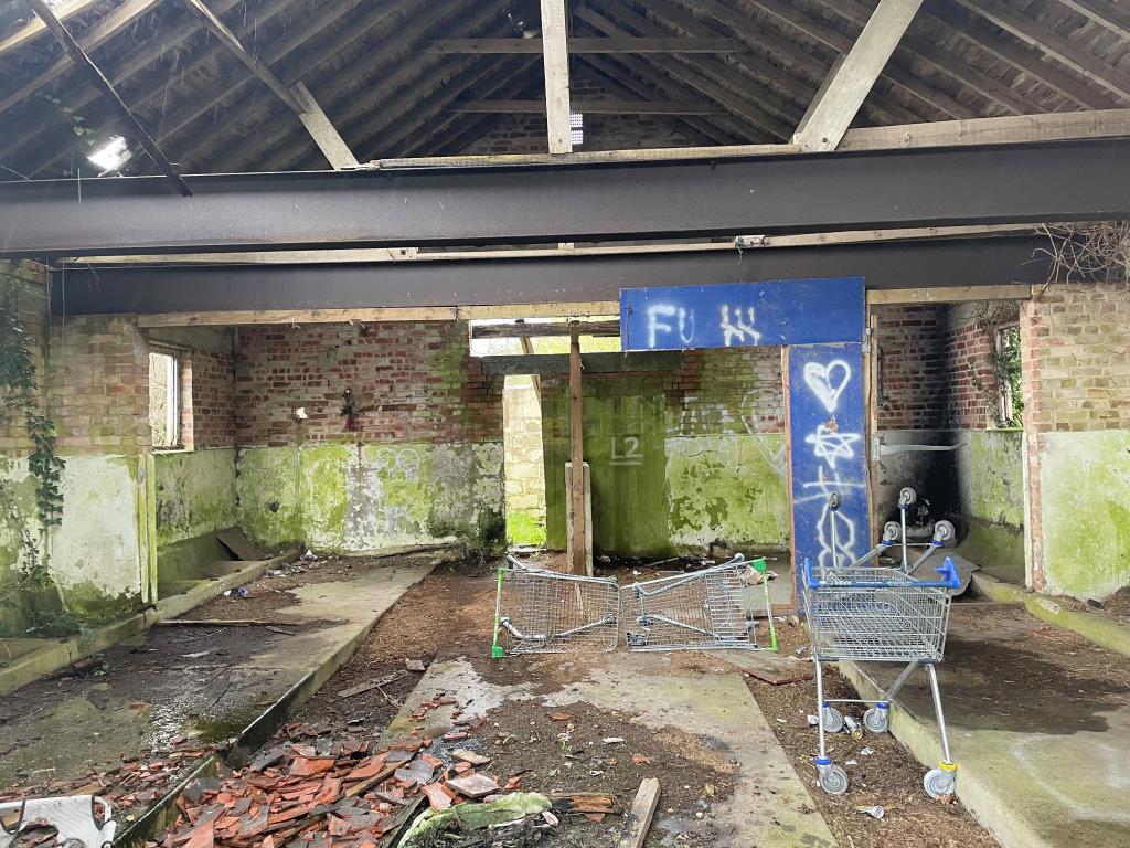 Lot: 18 - 13 PARCELS OF LAND WITH POTENTIAL IN STRATEGIC LOCATION - internal view of disused dairy building